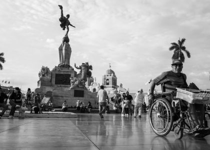A bustling scene in Trujillo's main square capturing daily life and architectural beauty in black and white.